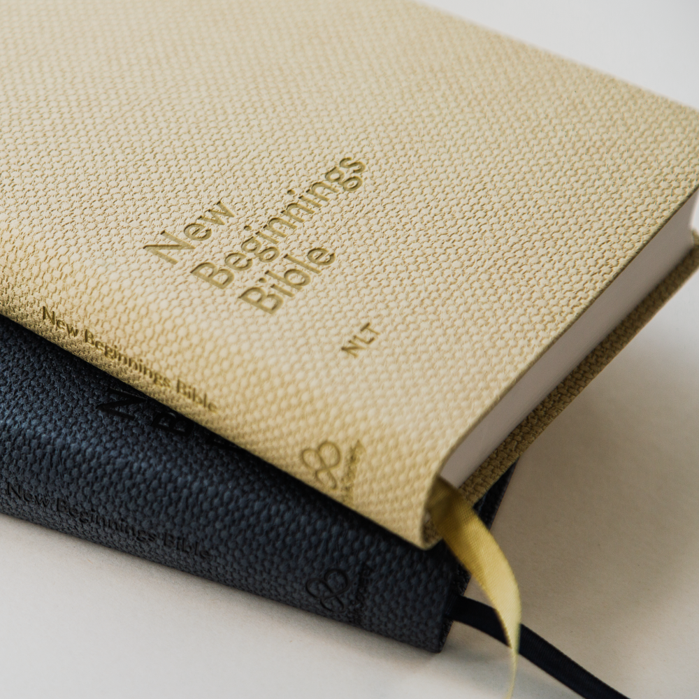 New Beginnings Bible in NLT translation elegant premium textured flexicover cover in Navy and Natural colour with ribbon bookmark.