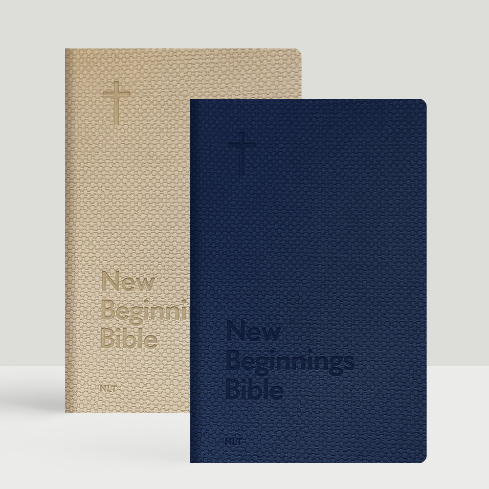 Box of 24 New Beginnings NLT Bibles with Navy and Natural textured faux leather covers, ideal for church outreach and new believers.
